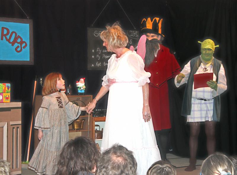 Getting on with the show.jpg - Village Child leads the Secret Fairy off for a cup of tea, leaving Giant and Shrek to "Get on with the show"